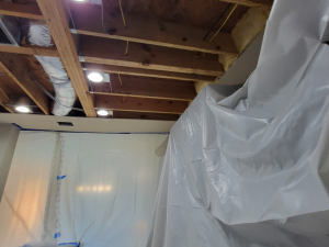 AC drainage leak that flooded the upstairs bathroom and downstairs kitchen. We set up containments, ran dehumidifiers and used air scrubbers while we removed contaminated materials.