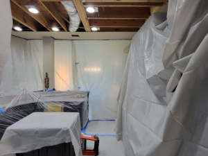 AC drainage leak that flooded the upstairs bathroom and downstairs kitchen. We set up containments, ran dehumidifiers and used air scrubbers while we removed contaminated materials.